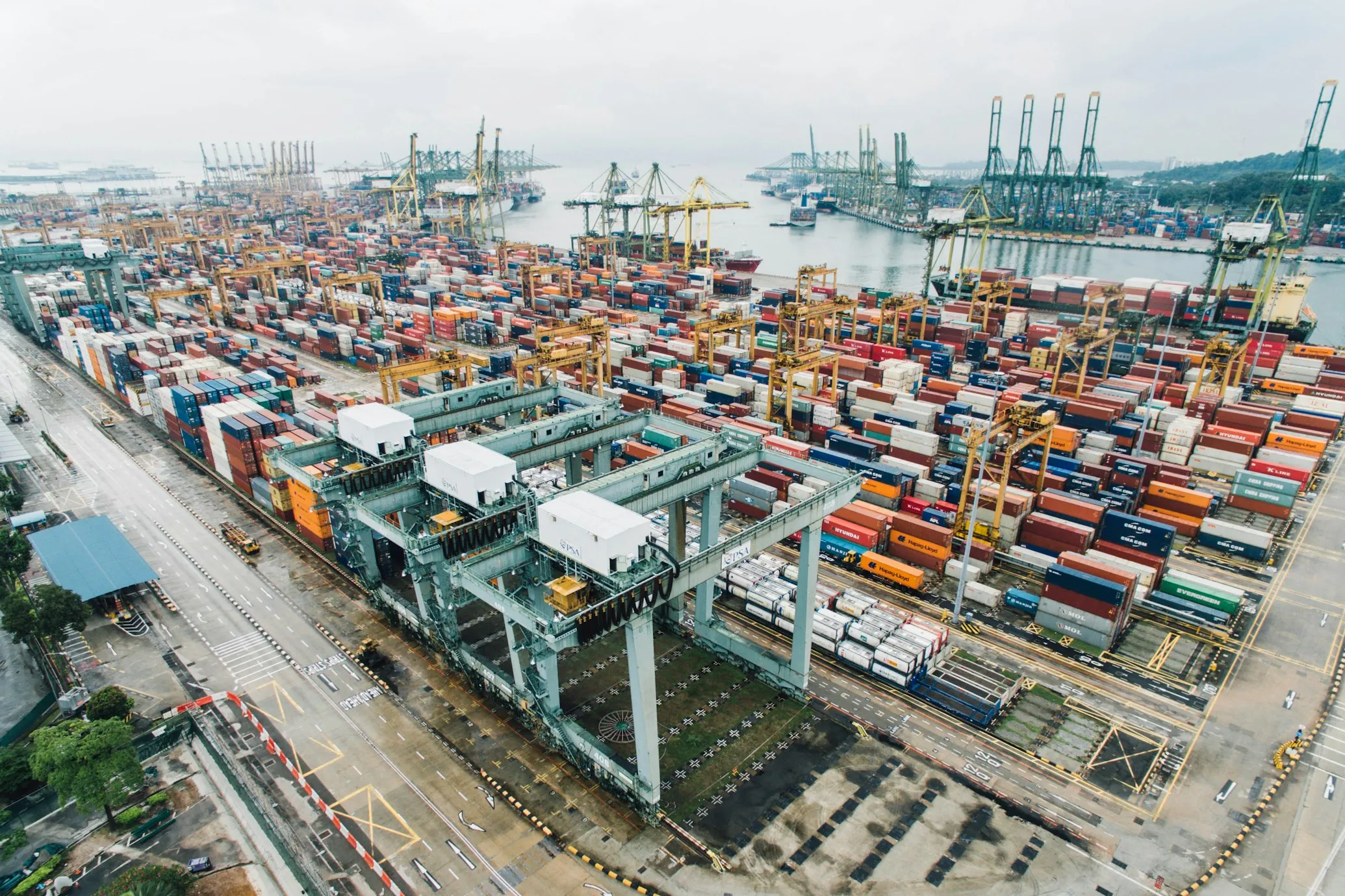 Aerial view of a container terminal with gantry cranes and stacked containers